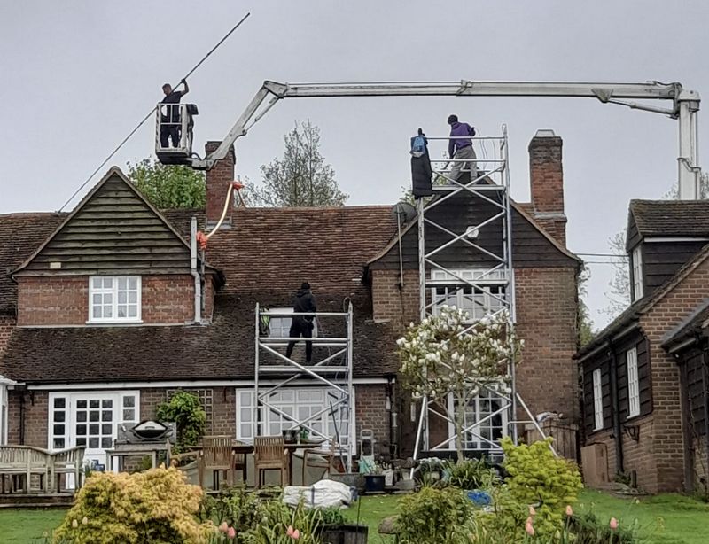 The Moss Cleaners using cherry picker and scaffolding to clean roof safely and professionally in South Hayling, Hampshire